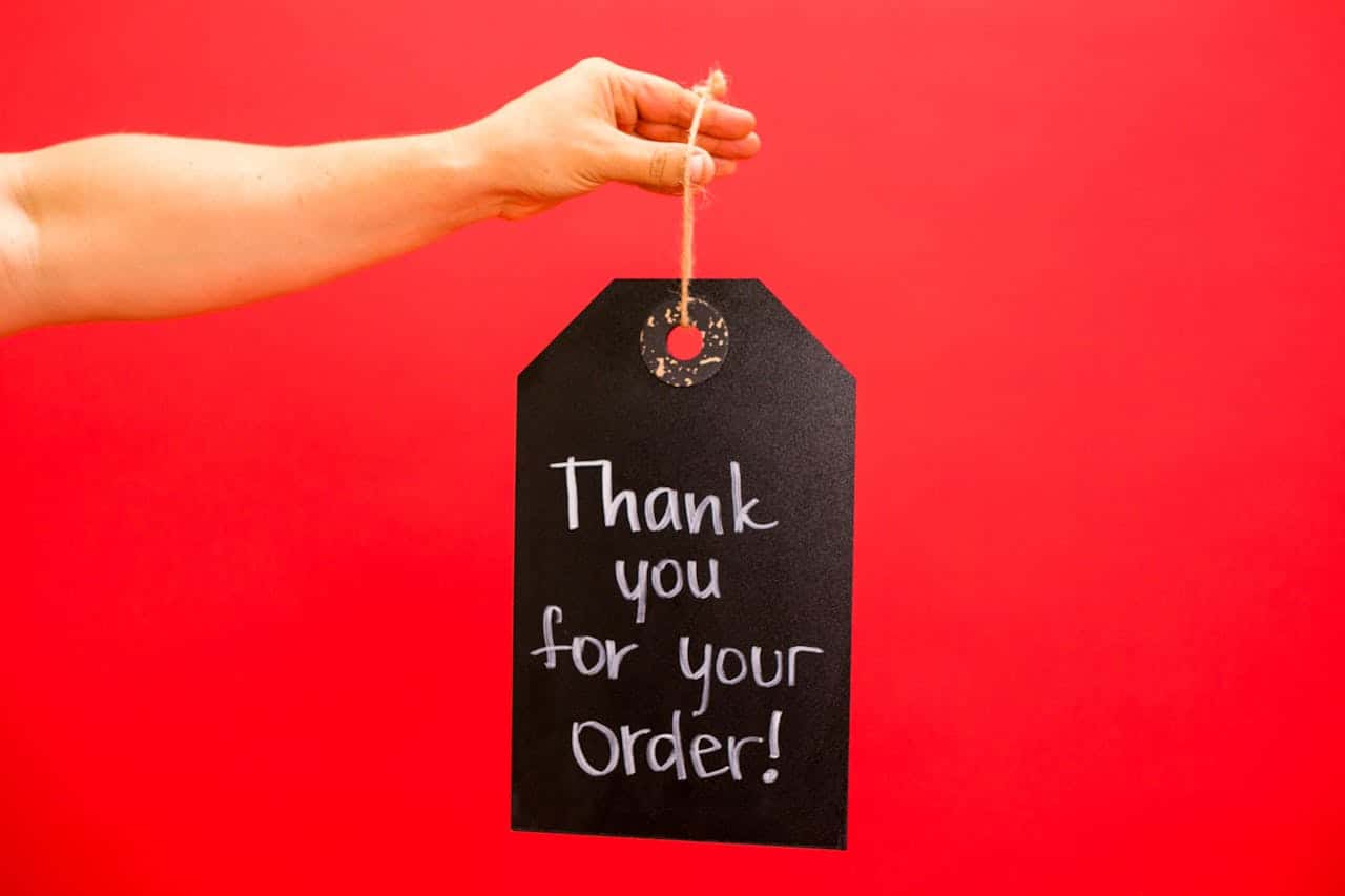 a person holding a thank you signage.